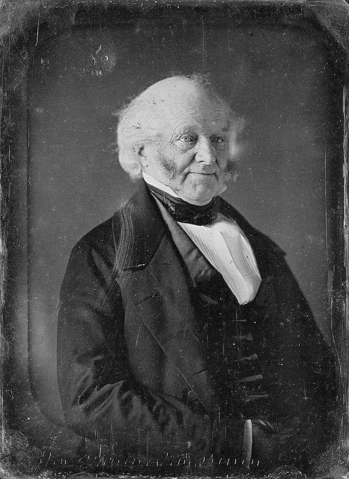A daguerreotype portrait of an elderly man with white side-whiskers, in a dark coat and high collar, looking slightly to one side.